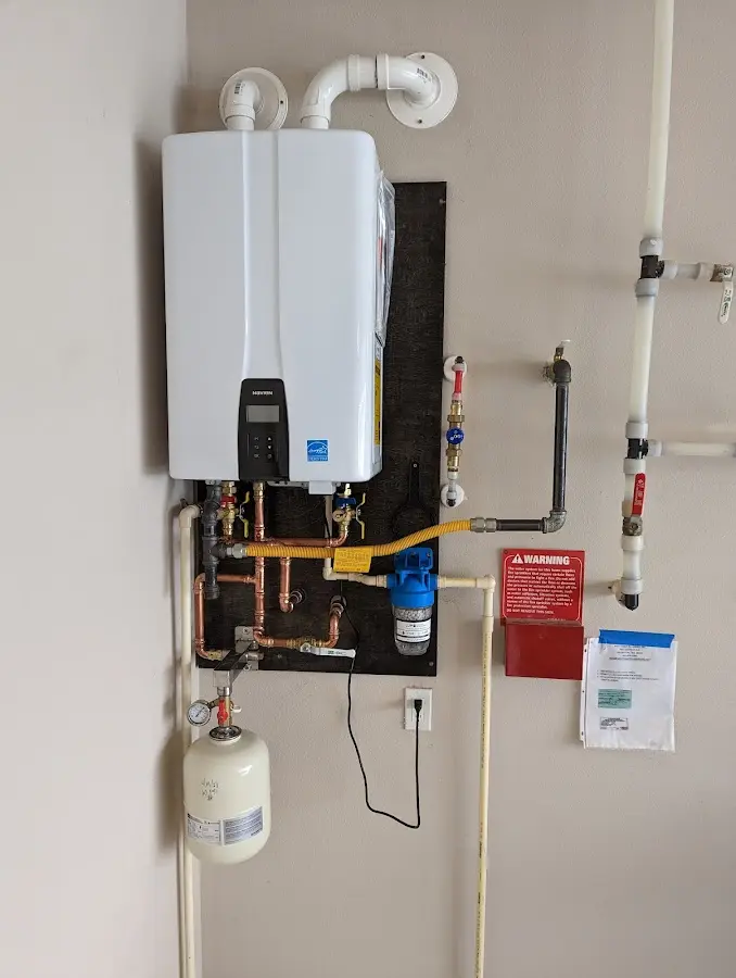 Professional plumber installing copper piping in a West Caldwell home